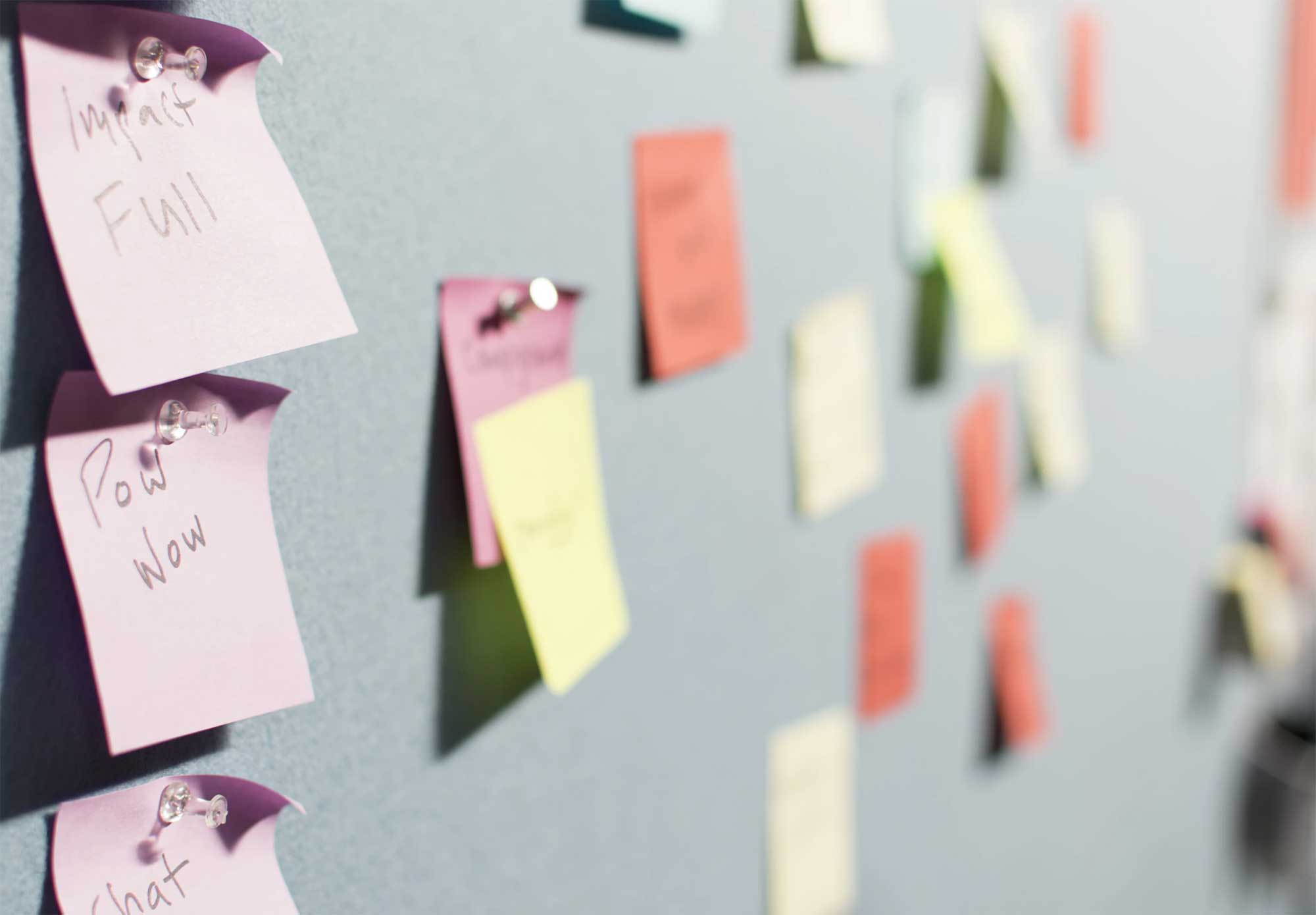 group of sticky notes on a white board