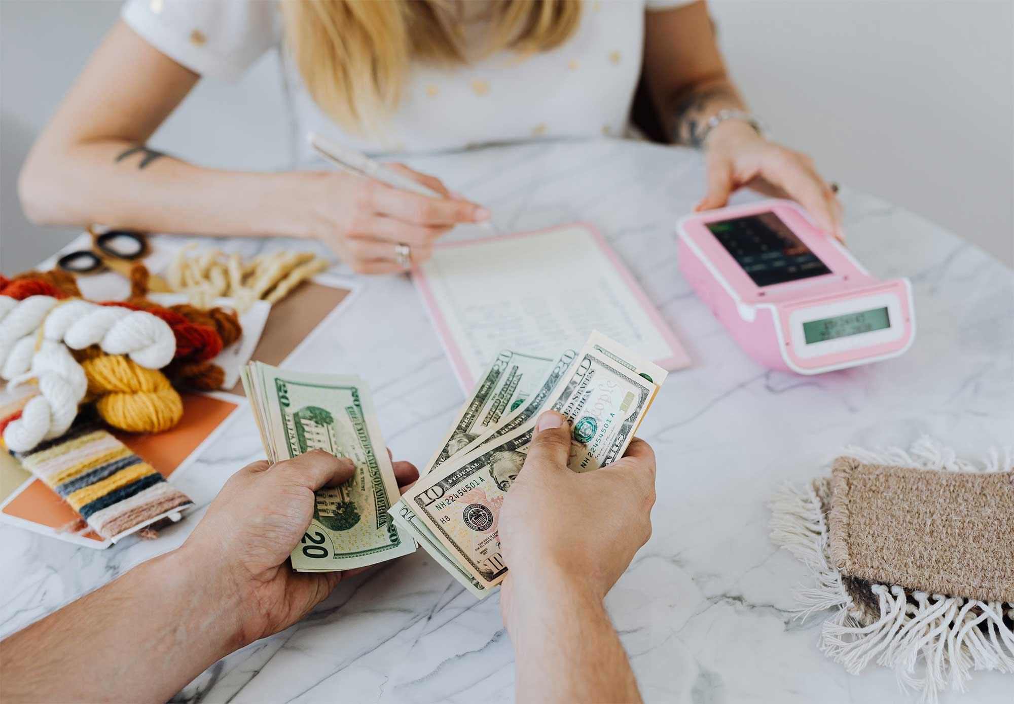 people sitting on desk and counting money