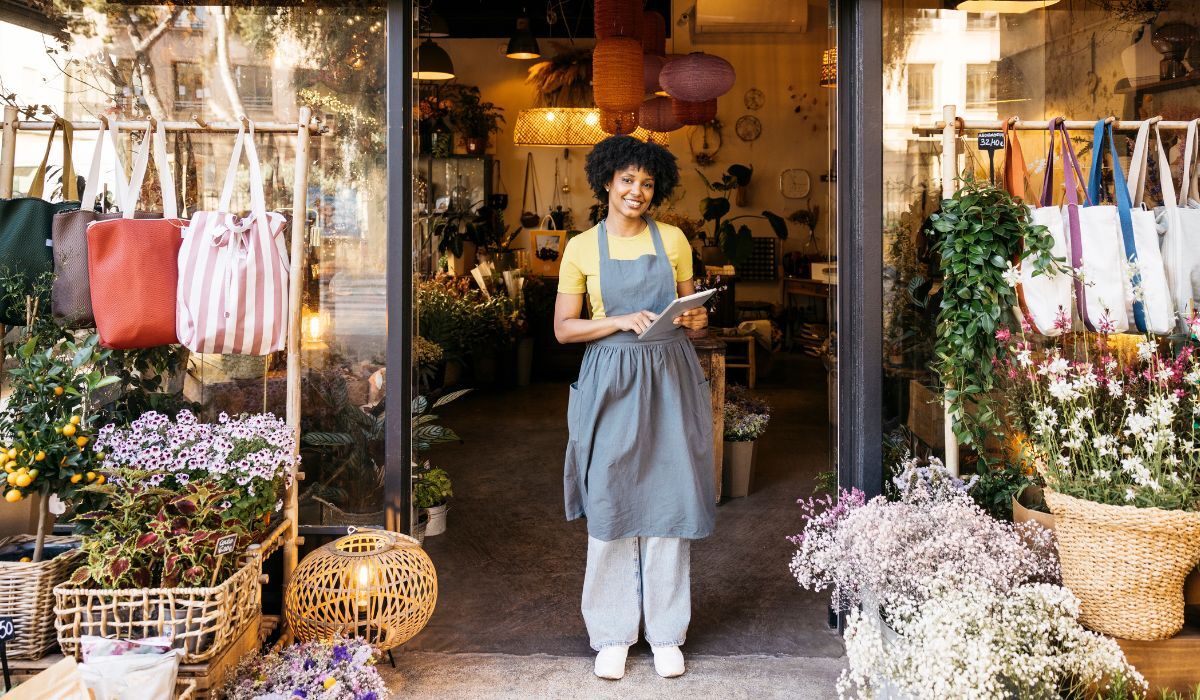 female florist standing in doorway of shop
